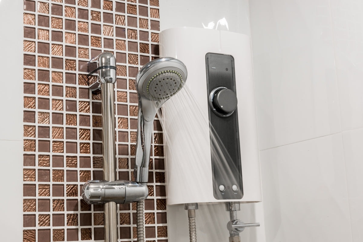 Electric shower unit with an adjustable temperature control and handheld shower head, delivering a steady flow of water during use.