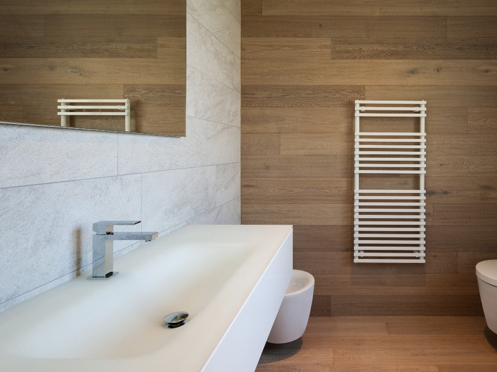 Modern bathroom featuring a white heated towel rail mounted on a wood-effect wall beside a floating vanity unit and large mirror.