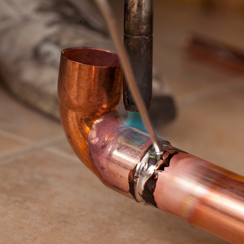 Example of plumbers soldering a copper joint