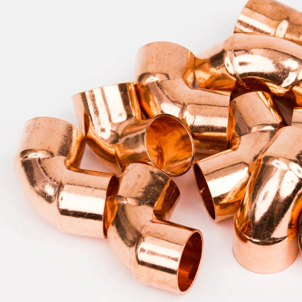 Pile of copper elbow pipe fittings