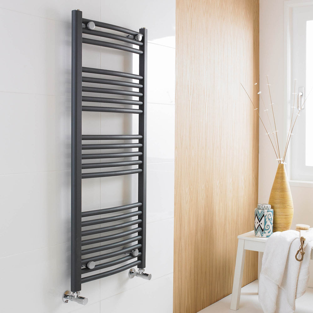 Black wall mounted towel rail in luxury bathroom with white tiles