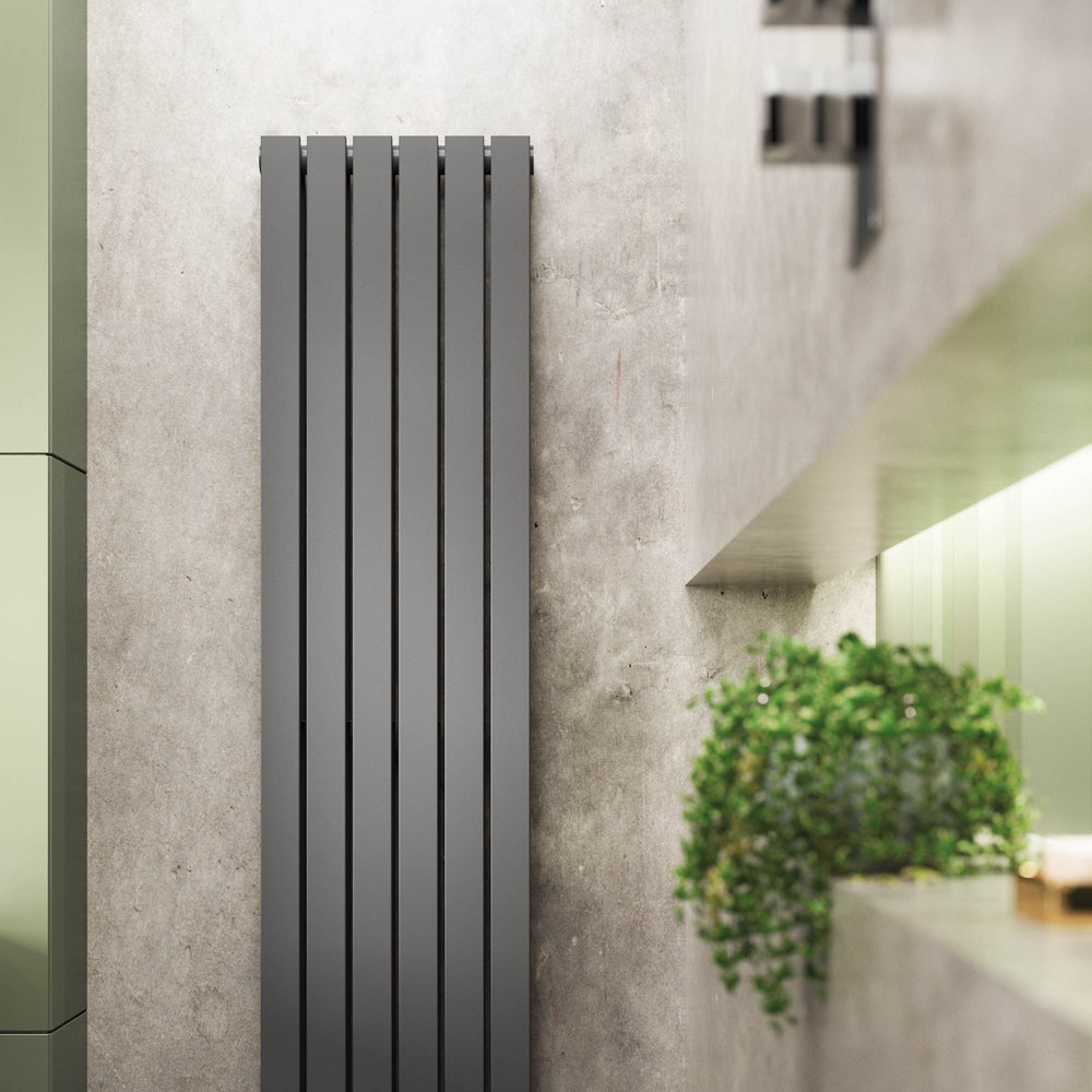 Black designer radiator in concrete finish bathroom with foliage