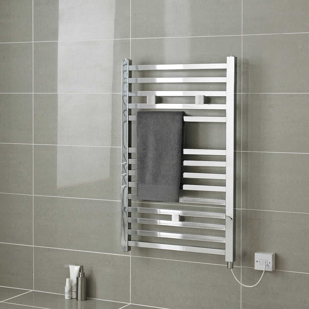 Chrome towel rail in a luxury green tiled bathroom setting