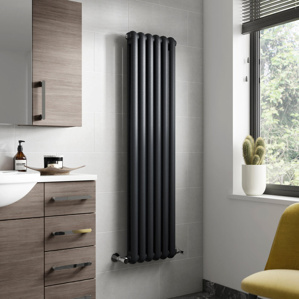 Black vertical radiator mounted on the wall in a luxury bathroom setting