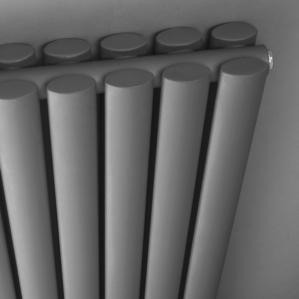 Close up of a wall mounted black vertical radiator