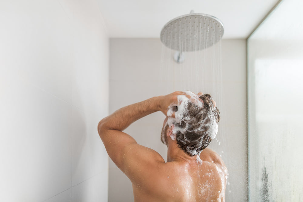 Man in shower washing his hair