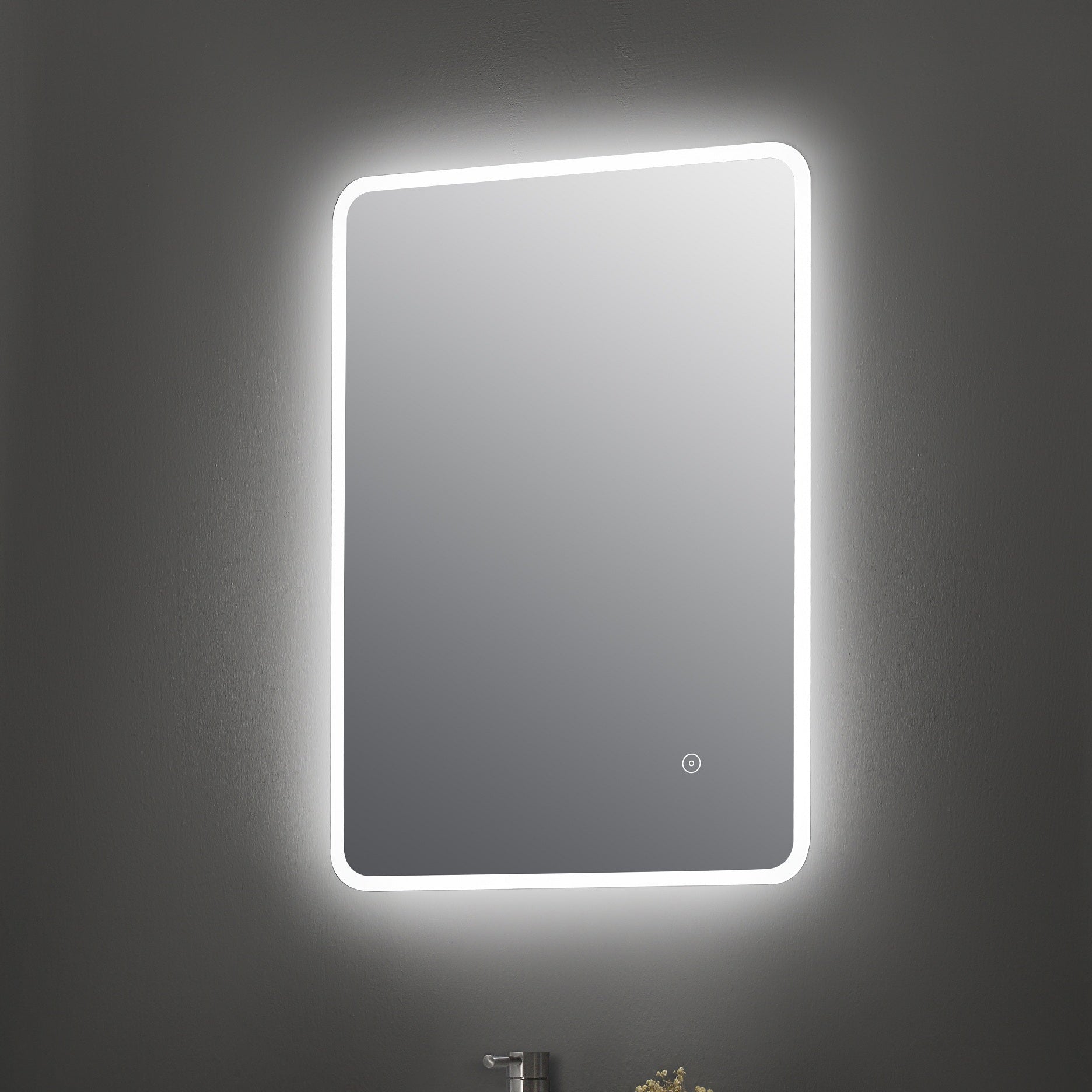 Illuminated bathroom mirror on dark wall with chrome tap